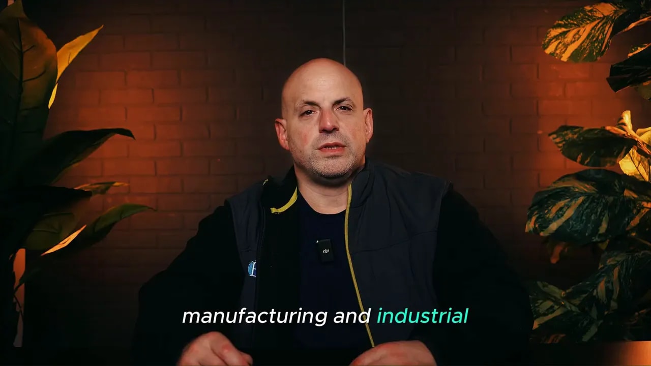 Presenter with on-screen caption 'manufacturing and industrial' highlighting industries that use SBA 504 green loans.